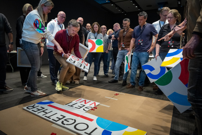 team putting together a painted jigsaw.