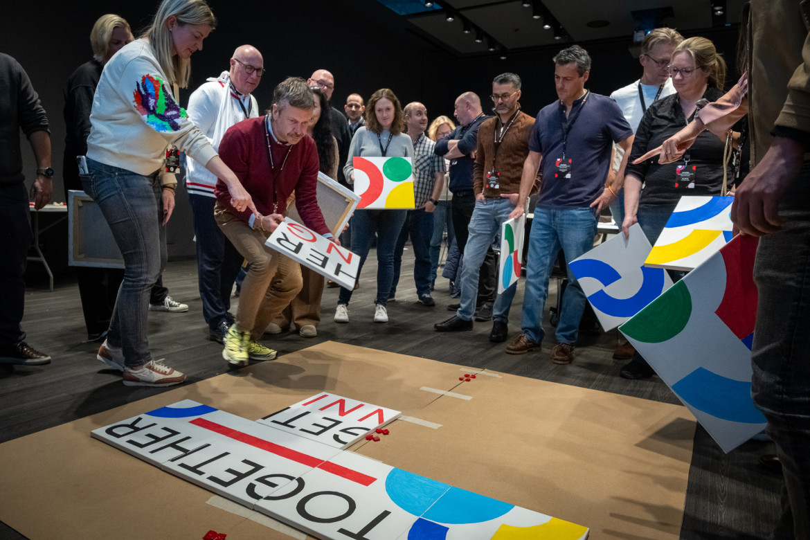 team putting together a painted jigsaw.