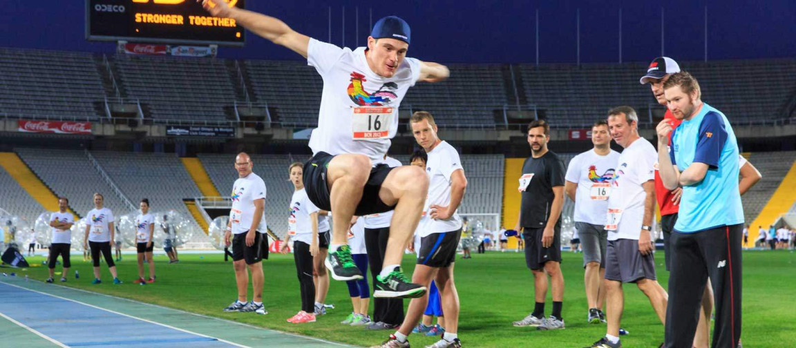 man taking part in olympic long jump activity.
